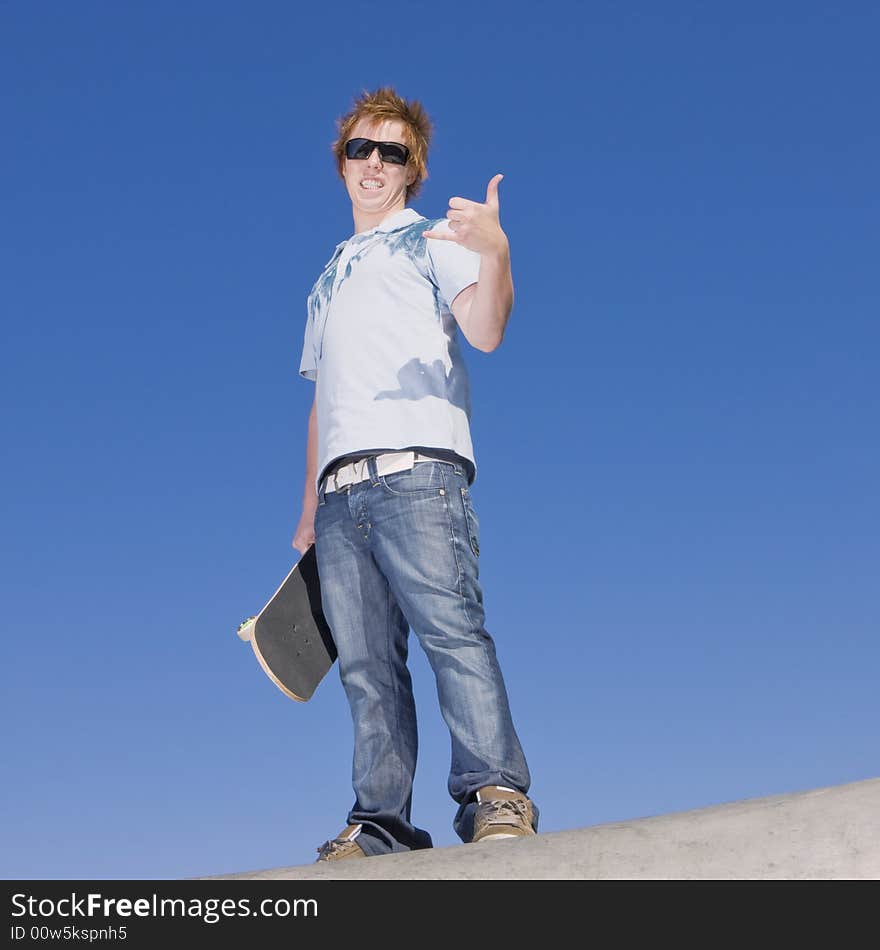 Teen Skater Atop Ramp