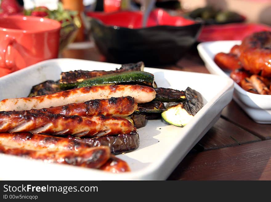 Grilled sausage and vegetables on table