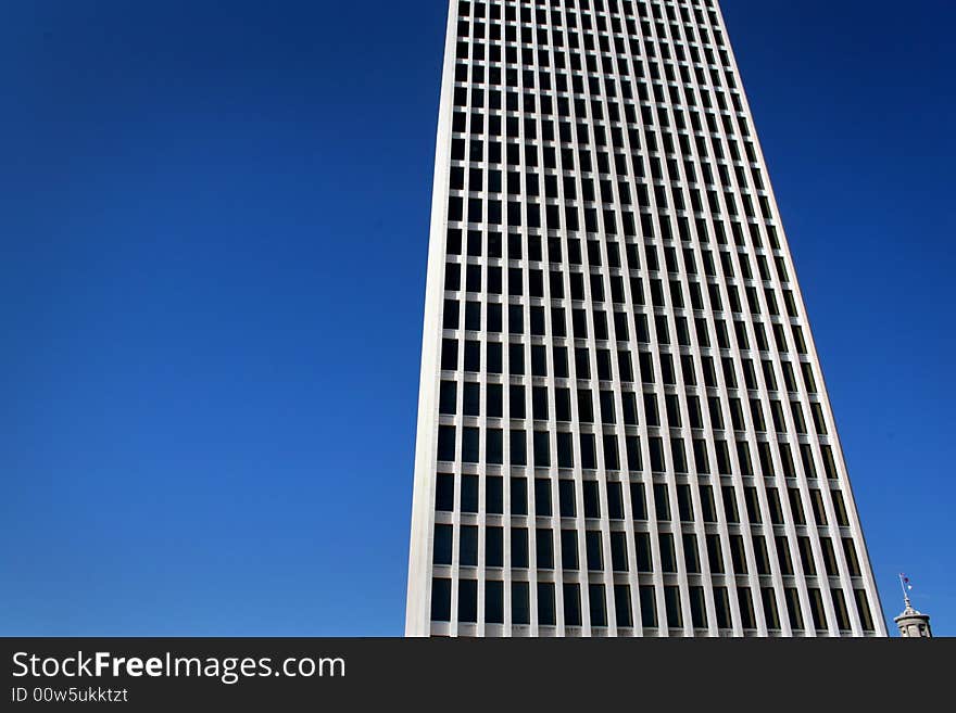 White modern skyscraper located in downtown. White modern skyscraper located in downtown