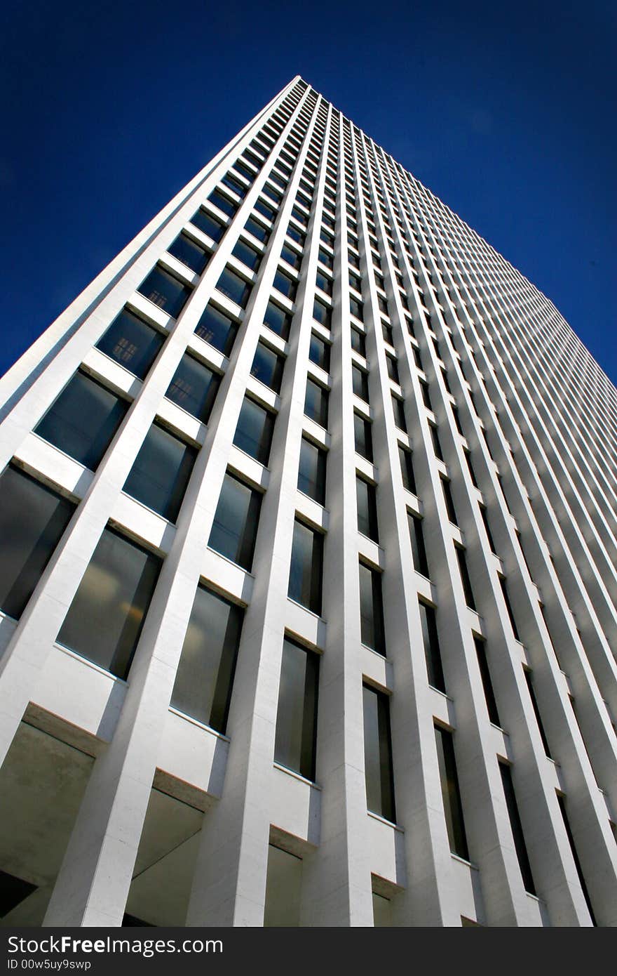 White modern skyscraper located in downtown. White modern skyscraper located in downtown