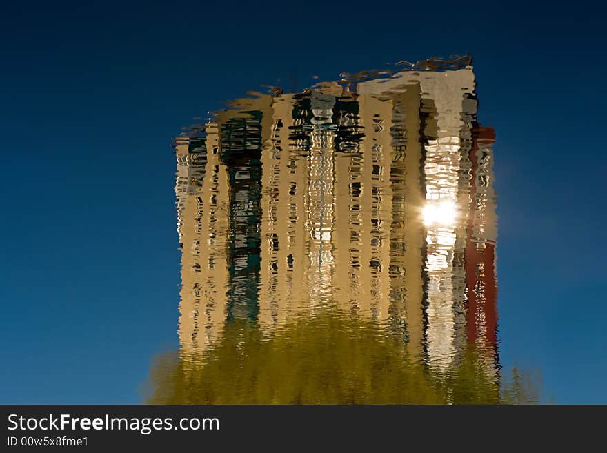 Reflection of a house in water on a background of the dark blue sky. Reflection of a house in water on a background of the dark blue sky