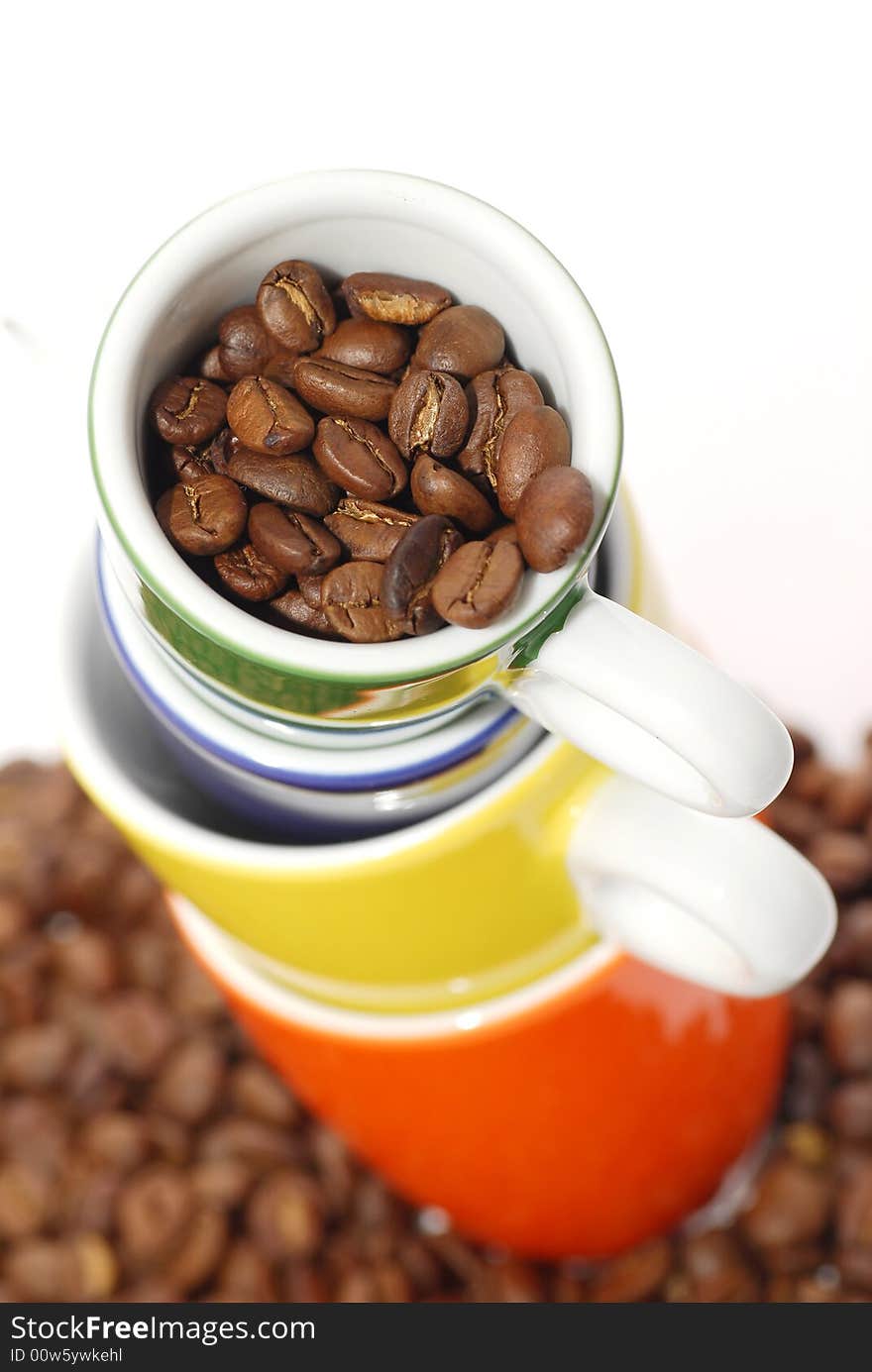 Cups  with roasted coffee beans