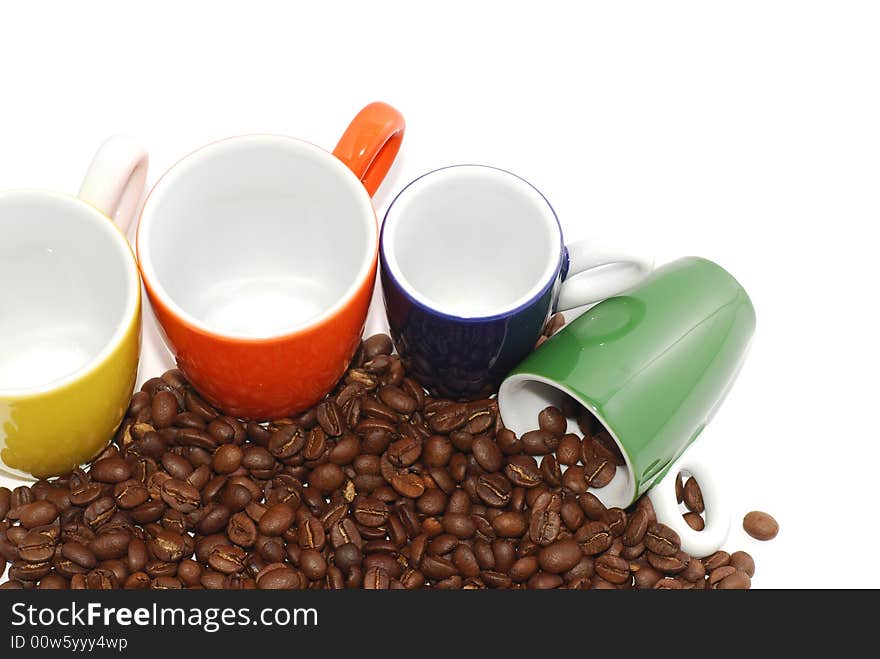 Cups with roasted coffee beans