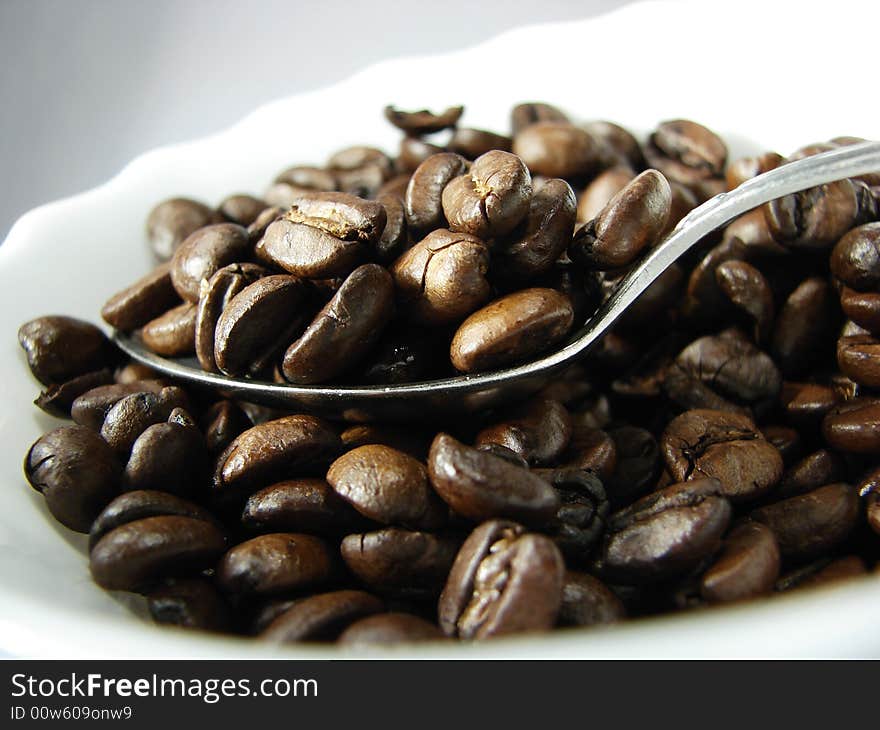 Natural coffee beans and spoon