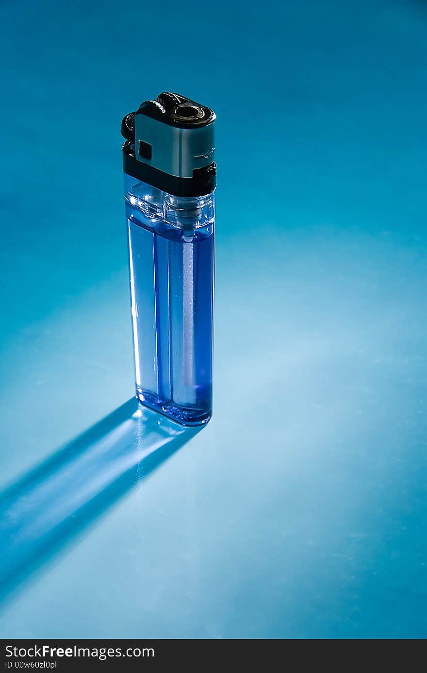 The inexpensive cigarette lighter on blue