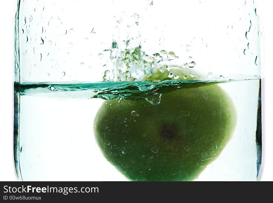 Splashing green apple on botlle