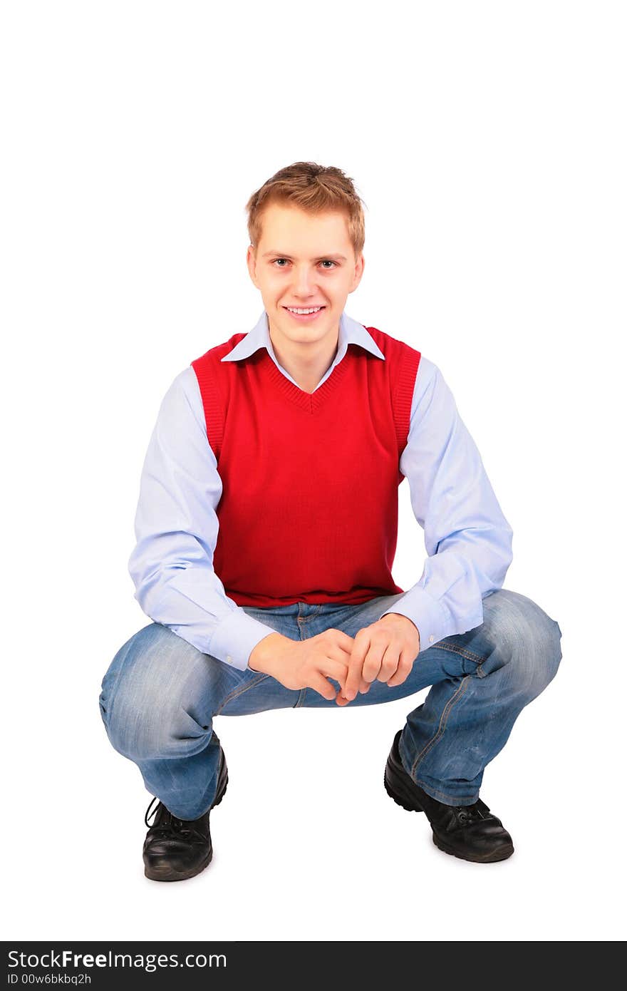 Boy in red jacket sits on white