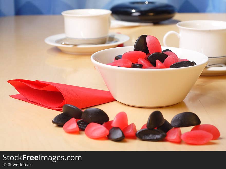 Candy with coffee cups in the background. Candy with coffee cups in the background