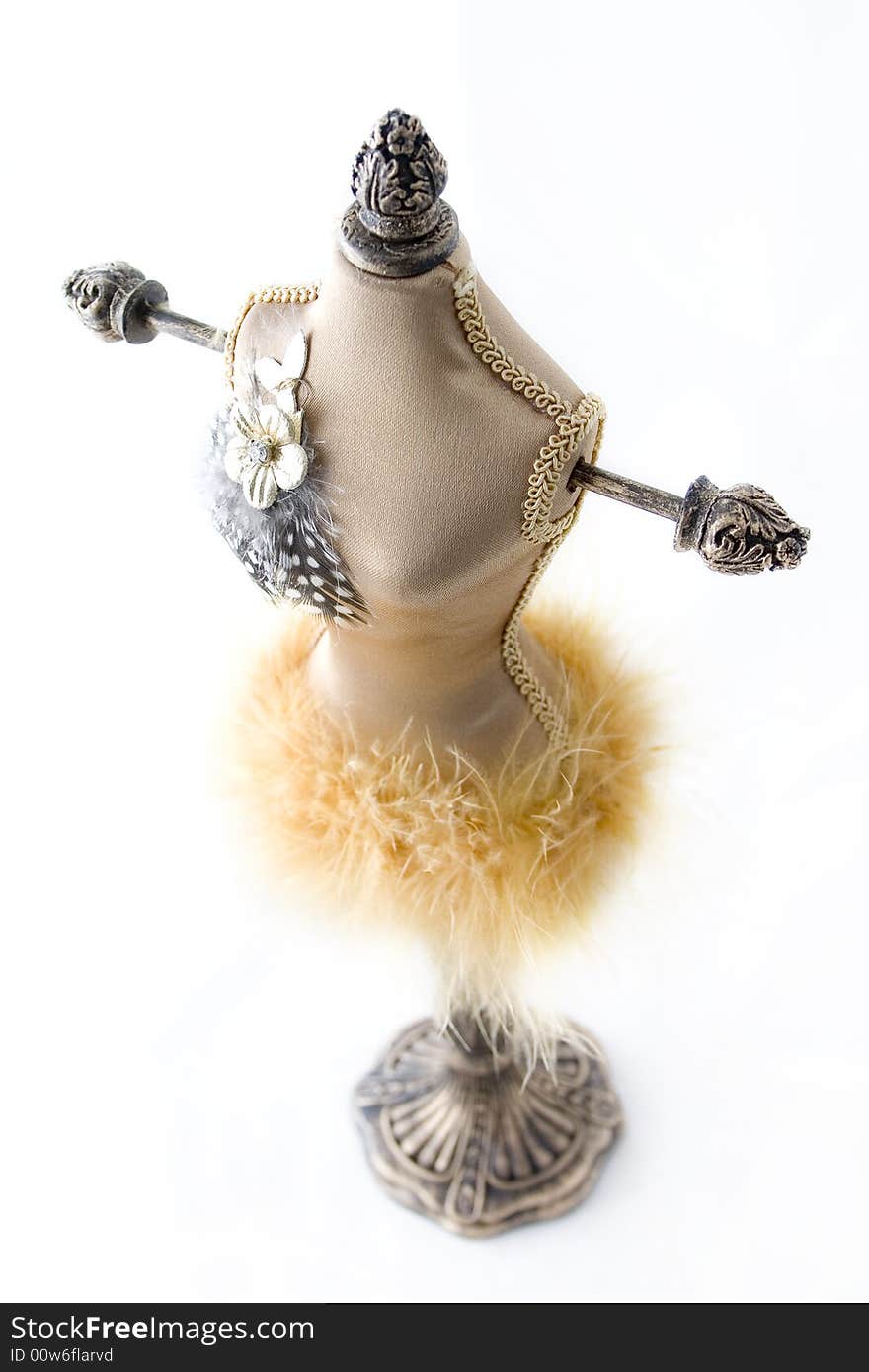 Wooden jewelry doll covered with material and feathers