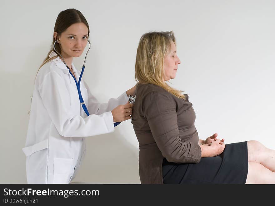 Older female patient being examined by a younger female doctor. Older female patient being examined by a younger female doctor