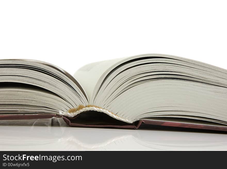 Isolated large open book on a white background, selective focus