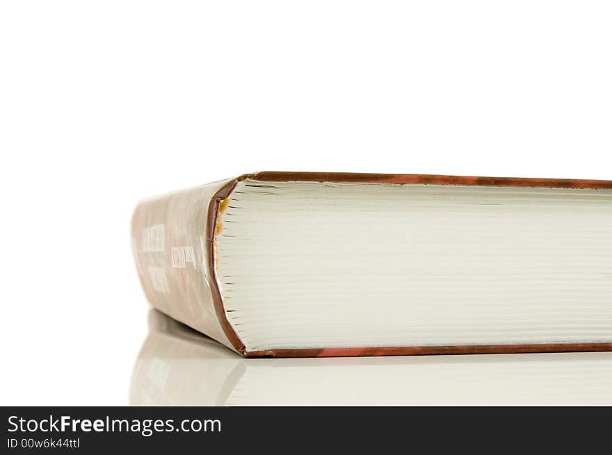 Isolated large closed book on a white background, selective focus