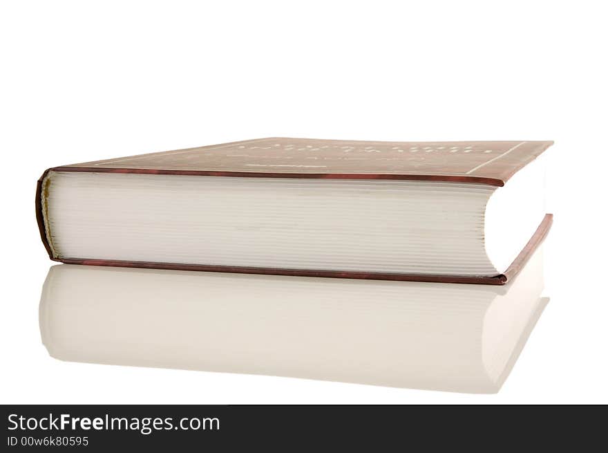 Isolated large closed book on a white background, selective focus