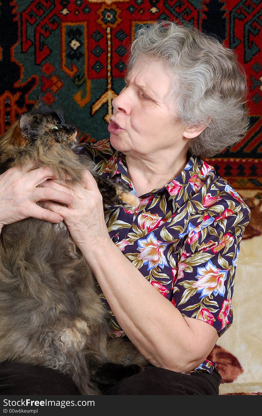 Grandmother talk with kitty on her hands