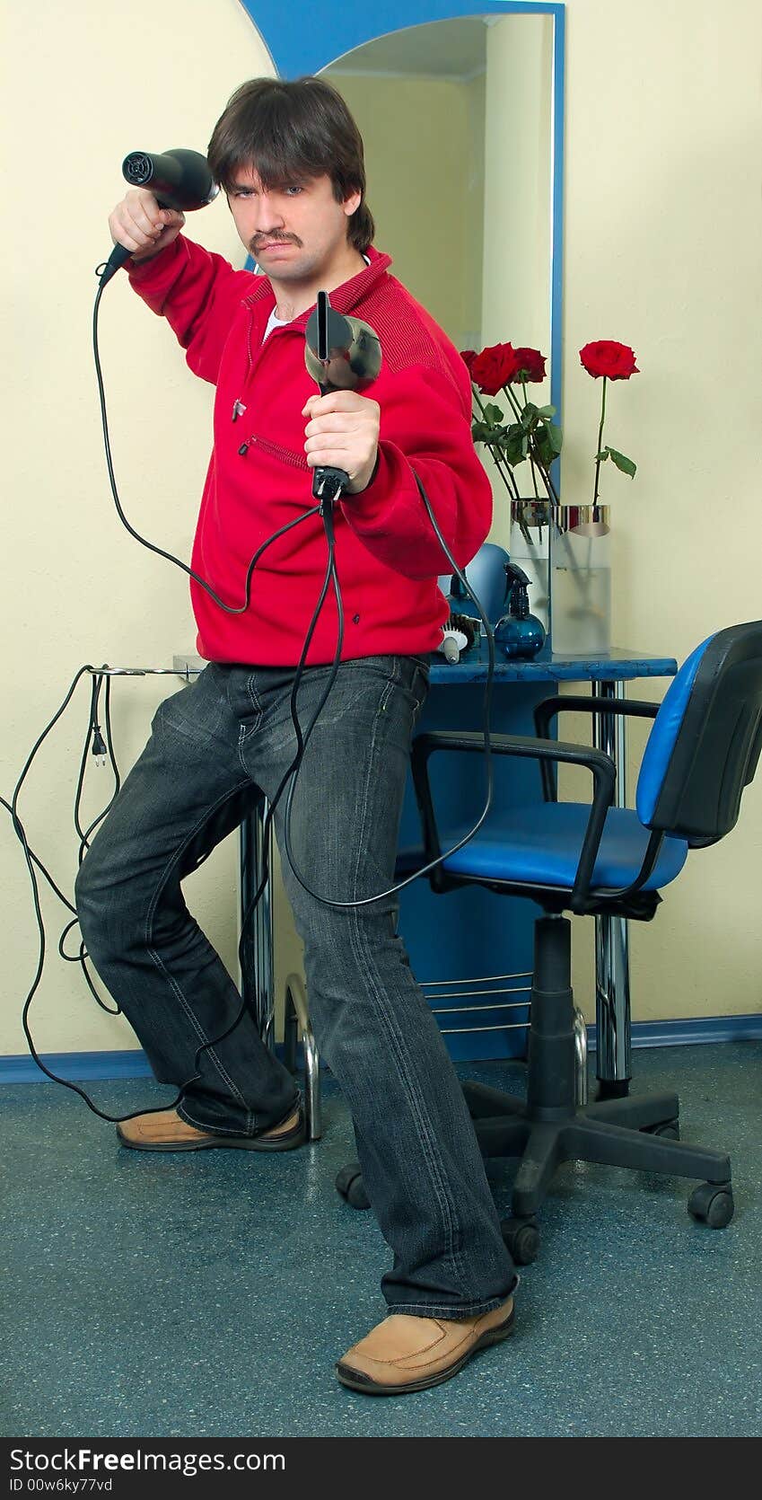 Funny warrior with two hair-drier in hairdressing saloon