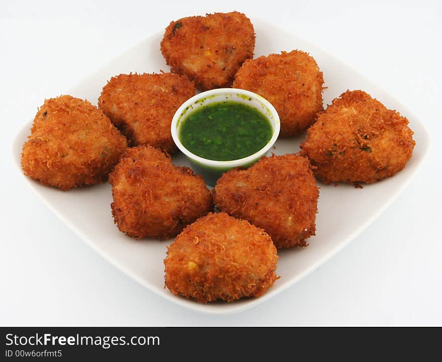 East indian  snack food garnished with green chillies. East indian  snack food garnished with green chillies