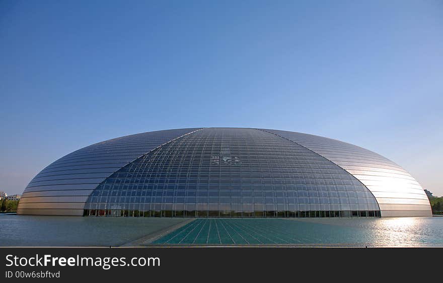 A modern theater building over the water.