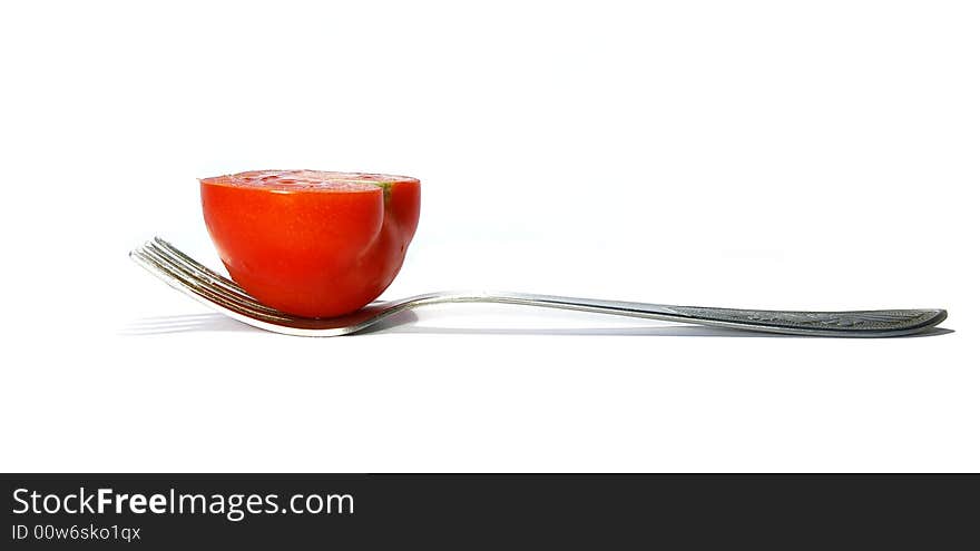 Fork and tomato isolated on a white background