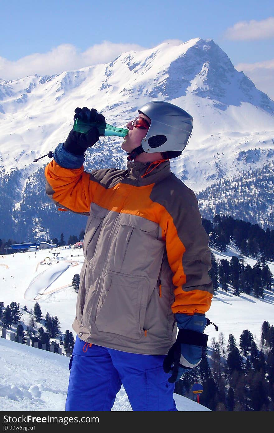 Snowboarder drinking mineral water