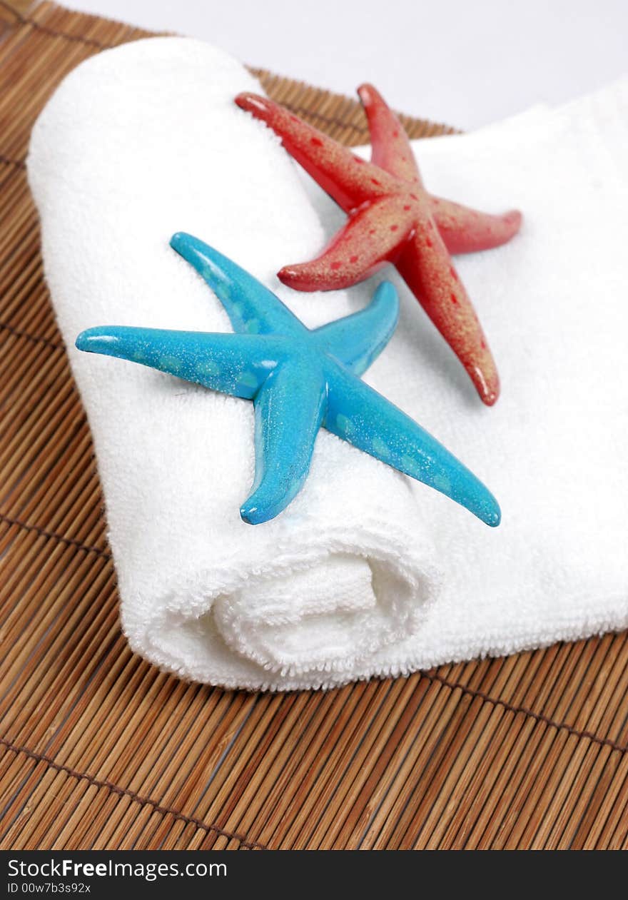 Colorful starfish on a white towel - spa and beauty. Colorful starfish on a white towel - spa and beauty.