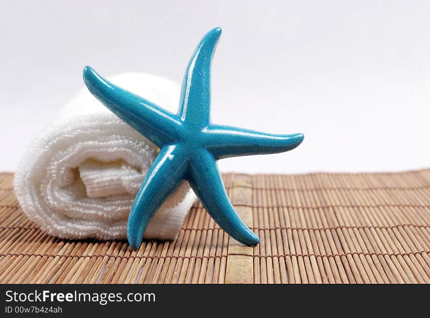 Colorful starfish on a white towel - spa and beauty. Colorful starfish on a white towel - spa and beauty.