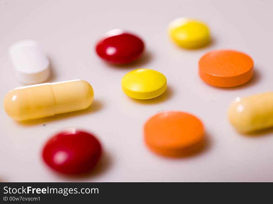 Pills on white background; Shallow depth of field.