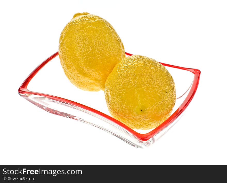 Two lemons on the glass saucer