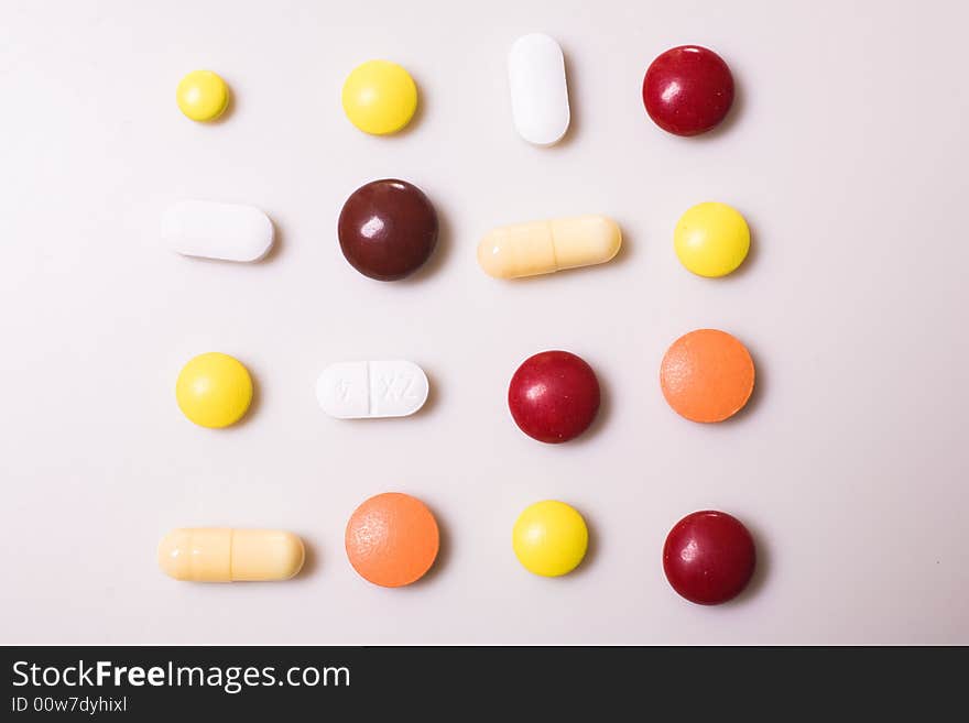 Pills on white background; Shallow depth of field.