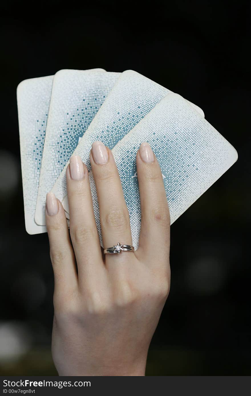 Woman´s hand with four playing cards. Woman´s hand with four playing cards