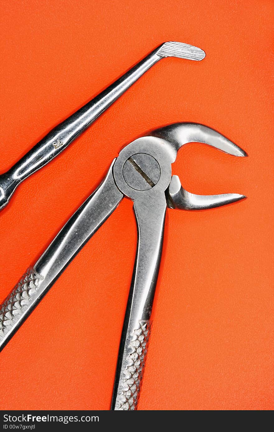 Stomatologic Tools On An Orange Background