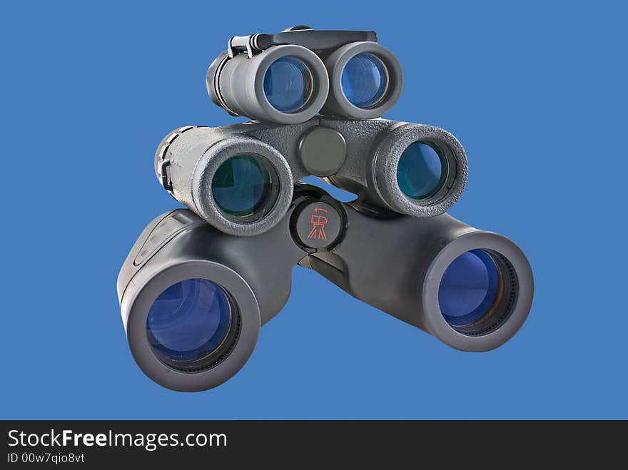 Binoculars of various sizes isolated on a blue background.