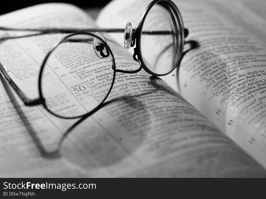 Glasses laying on open Bible. Glasses laying on open Bible