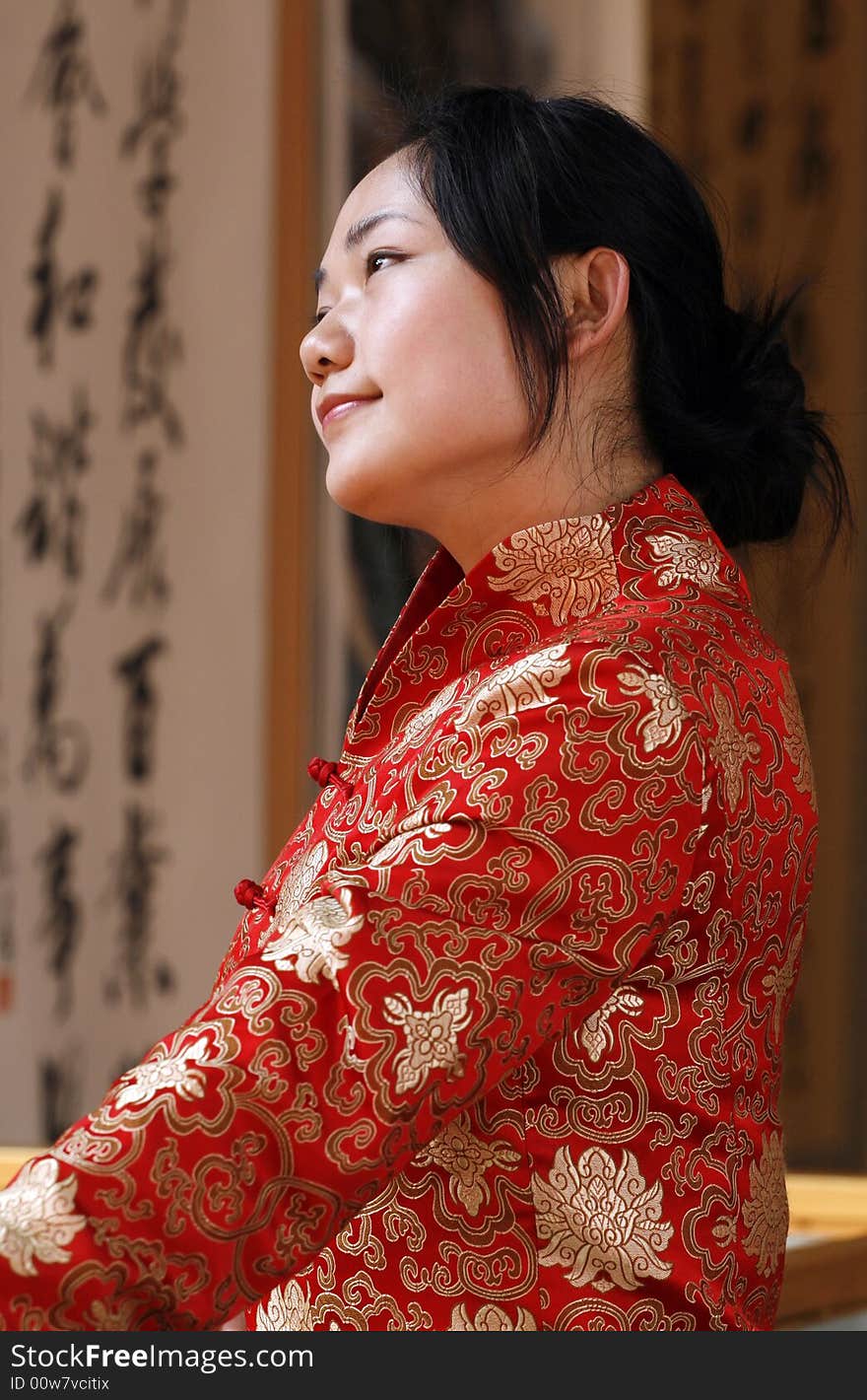 One in traditional dress Chinese girl in watch China calligraphy exhibit. One in traditional dress Chinese girl in watch China calligraphy exhibit.