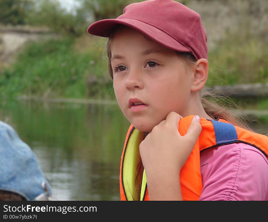 girl looks somewhere from boat