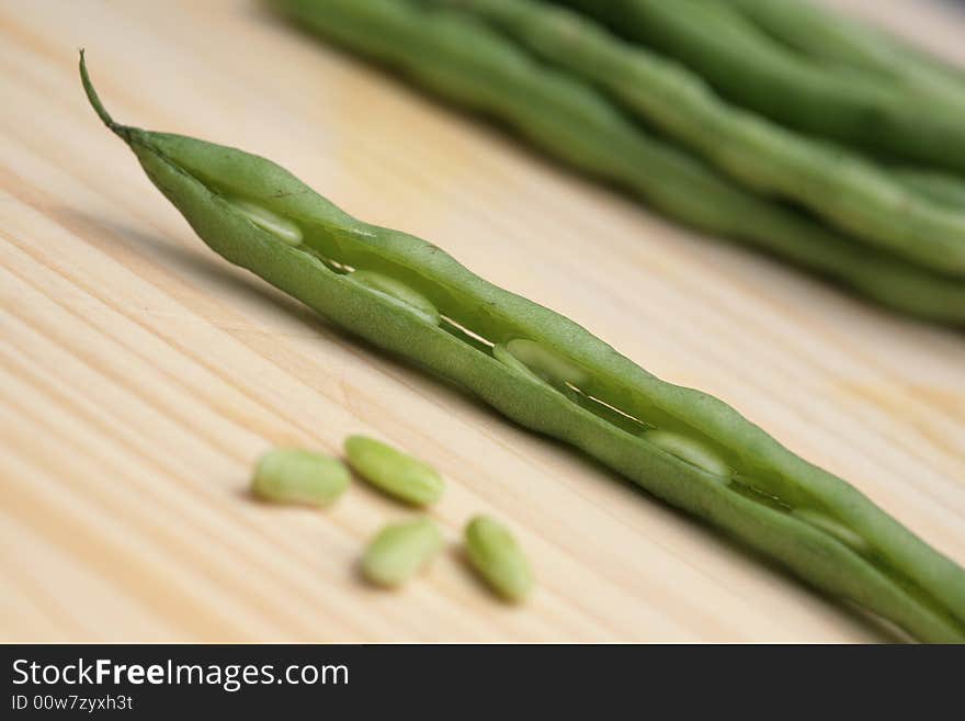 Fresh green beans on wood cutting board