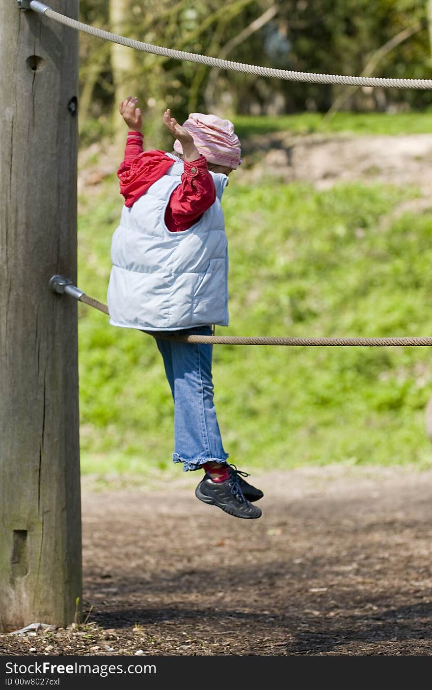 Little girl on an adventure playground. Little girl on an adventure playground