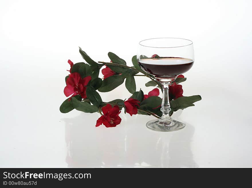 Wine glasses and red flowers. Wine glasses and red flowers