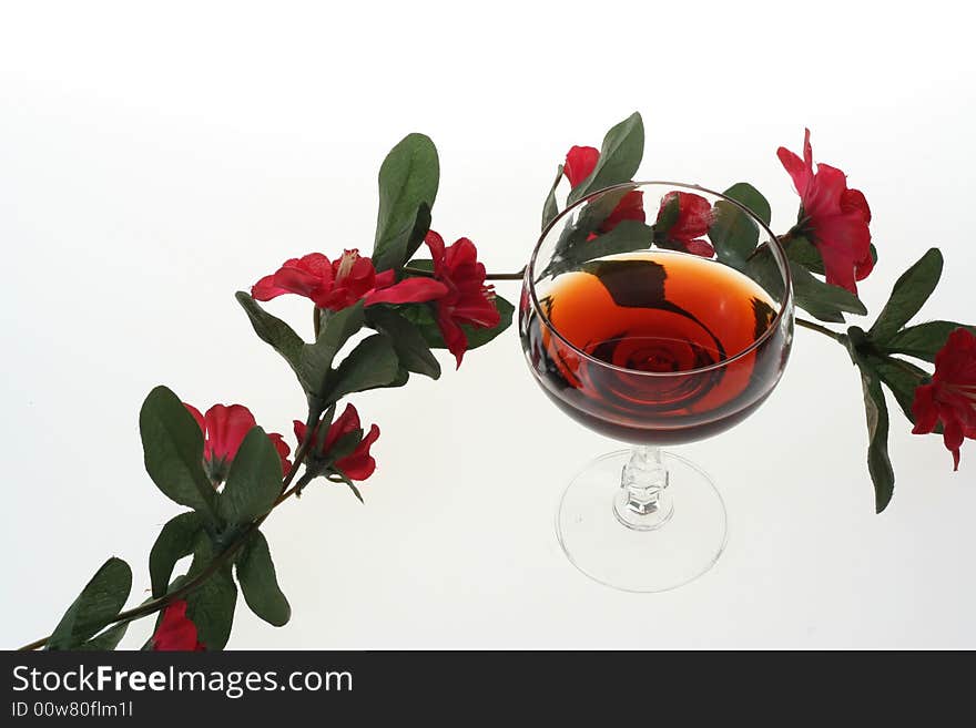 Wine glasses and red flowers. Wine glasses and red flowers