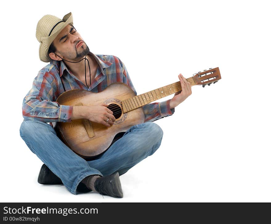 Man with hat and guitar sitting on floor and singing, isolated. Man with hat and guitar sitting on floor and singing, isolated
