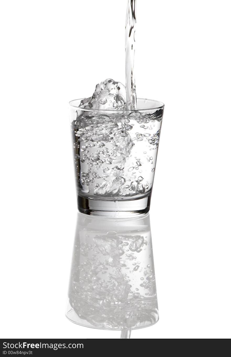 Water pouring into clear glass isolated on white background. Water pouring into clear glass isolated on white background