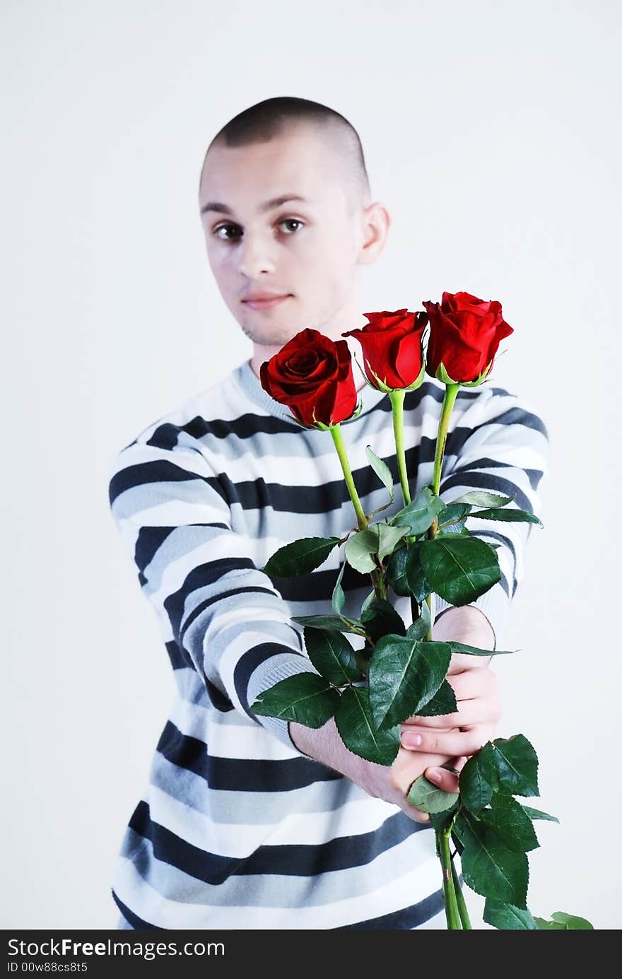 Young man with red roses at white background. Young man with red roses at white background