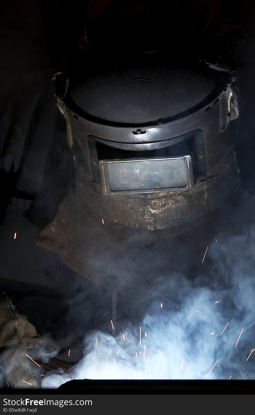 A welder working at shipyard at night. A welder working at shipyard at night