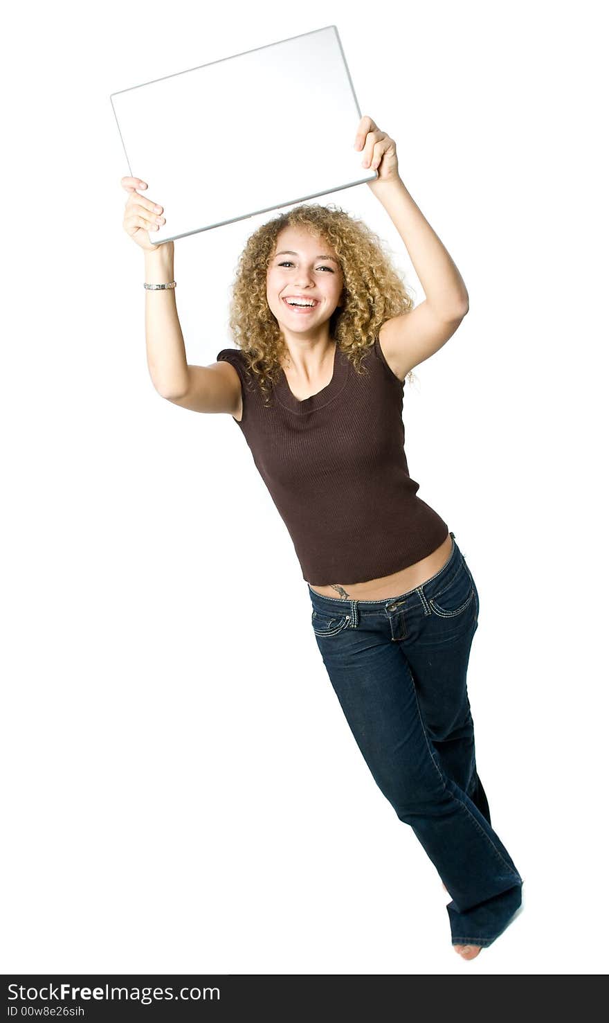 A beautiful young women holding her portable computer above her head. A beautiful young women holding her portable computer above her head