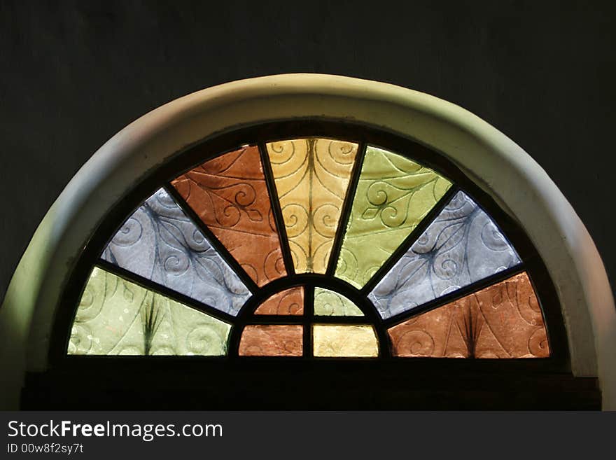 A window in a church with many colors. A window in a church with many colors