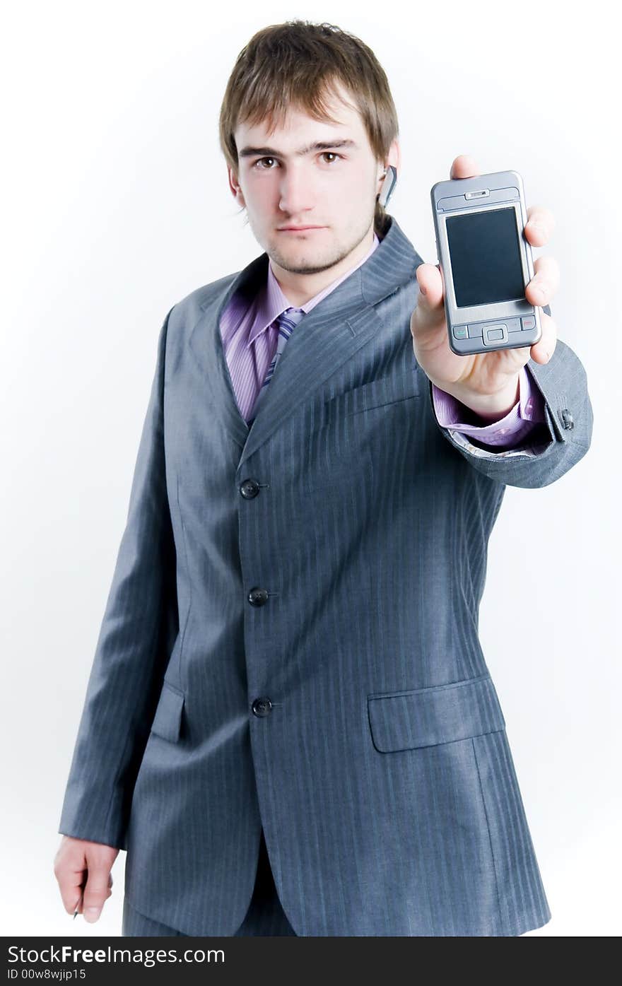 Businessman showing phone, focus on phone, isolated on white background