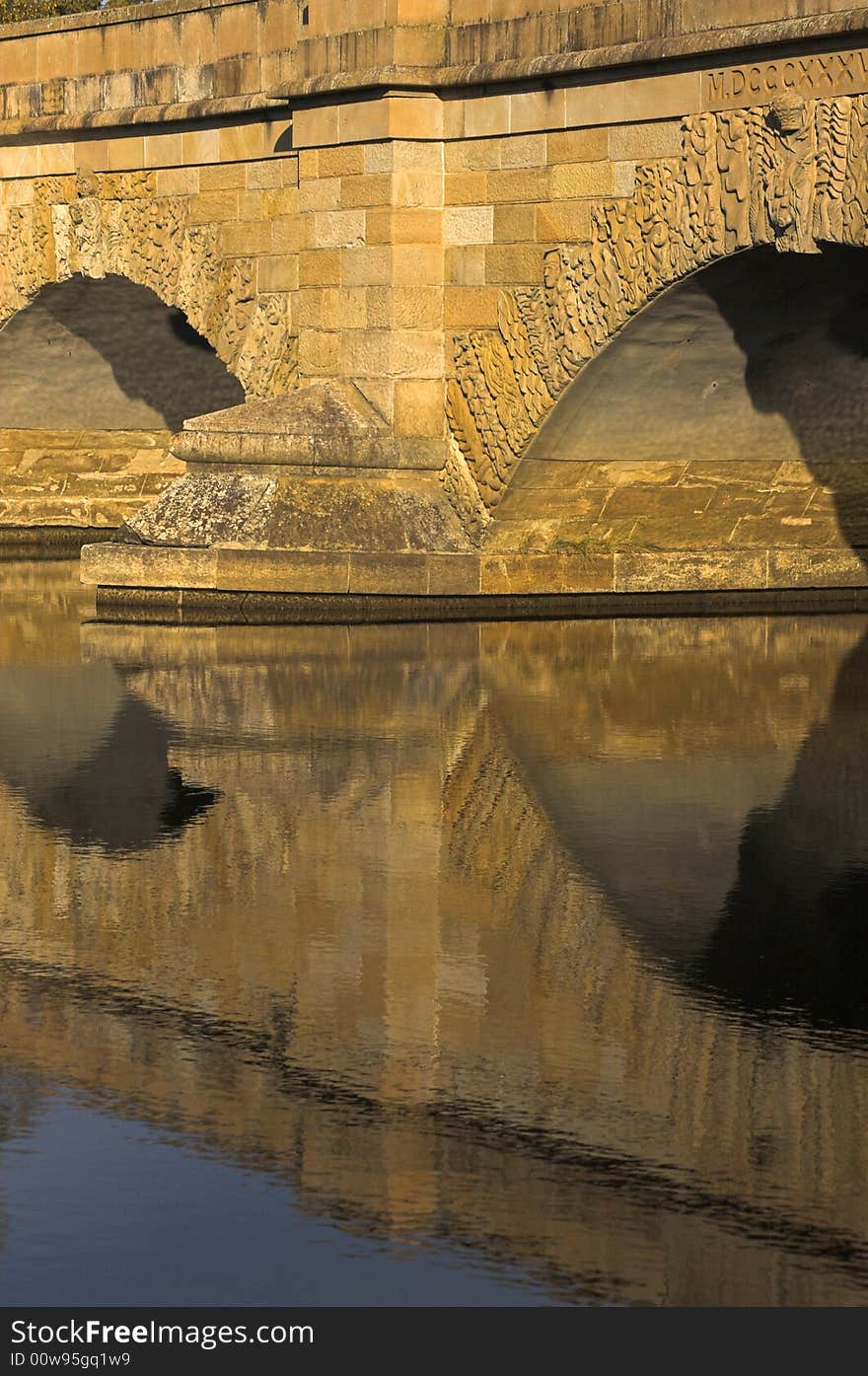 The pylon and two arches of a bridge over a small river.  Bridge was built in 1800's, Ross, Tasmania. The pylon and two arches of a bridge over a small river.  Bridge was built in 1800's, Ross, Tasmania.