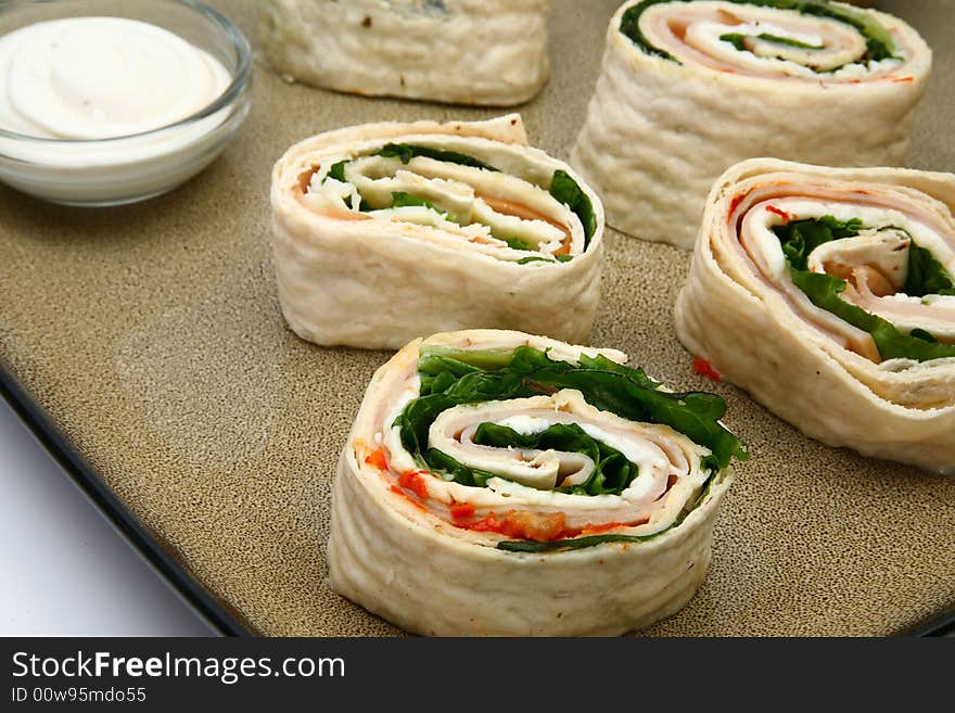 Spicy ham, provolone and spinach wrap with ranch dressing on side. Spicy ham, provolone and spinach wrap with ranch dressing on side.