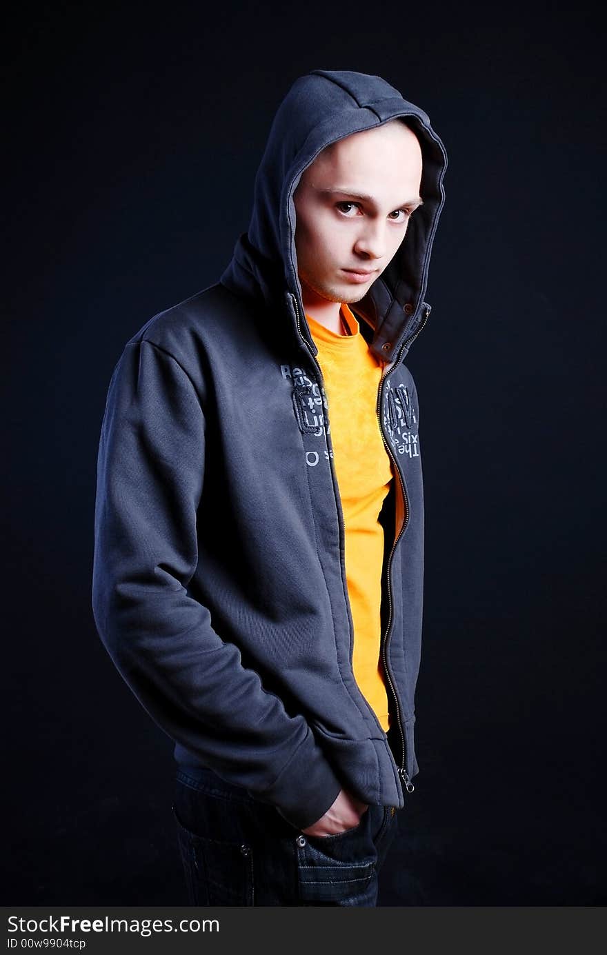 Fashion portrait of young man at black background. Fashion portrait of young man at black background