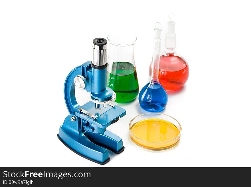 Various colorful flasks and blue microscope over white background