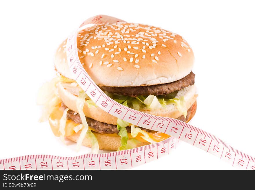 Bread with fried meat, cheese, onion, lettuce and measuring tape isolated on a  white background. Bread with fried meat, cheese, onion, lettuce and measuring tape isolated on a  white background.